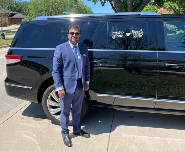Chauffeur with Black Wedding Vehicle